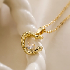 Minimalist gold plated necklace with a melting heart pendant and zircon stone center