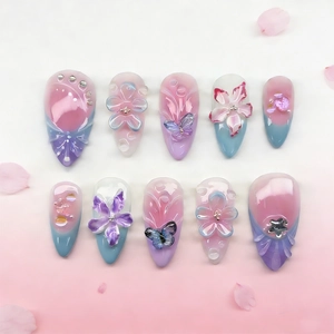 Handmade 3D press-on nails with floral butterfly charms and gradient rhinestones