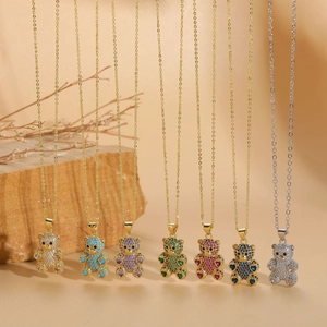 Close-up of bear pendants with colorful pavé cubic zirconia and 14K gold plating
