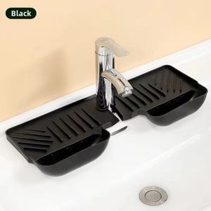 Close-up of black silicone faucet splash guard with drainage ridges and sponge holders