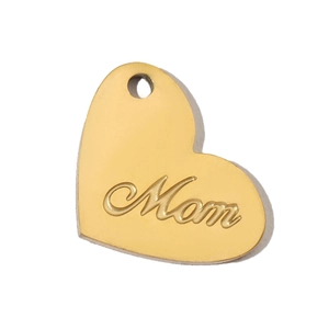 Detailed view of a gold heart-shaped pendant with Mom engraving in polished stainless steel