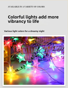Detail of multi-color star-shaped LED fairy lights with green foliage decoration