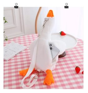 Detail of cute white goose plush bag showing internal capacity for a smartphone