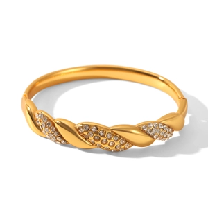 Detail of 18k gold plated stainless steel twisted bangle with sparkling pavé diamonds