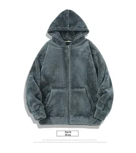 Detail of dark grey fleece hoodie with reversible fabric and metallic zipper closure