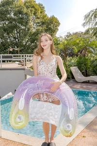 Detail of glitter ink painting U-shaped inflatable pool float with handles and backrest