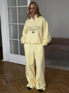 Women's pale yellow sports set with half-zip hoodie and pants featuring Saint Louis embroidery