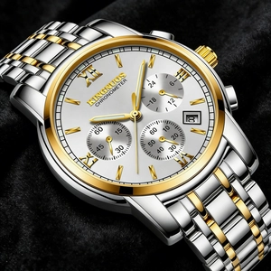 Detailed macro view of a luxury two-tone men's stainless steel watch with calendar dial