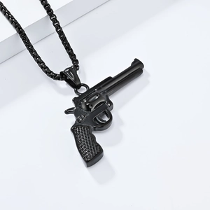 Detailed view of matte black revolver pistol pendant with thick matching ball chain