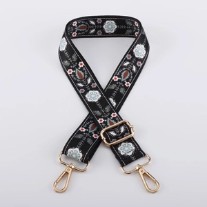 Detail of adjustable floral fabric strap with vintage pattern and gold metal hooks
