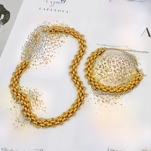 Luxury 18K gold plated thick mesh chain necklace and bracelet jewelry set on a book
