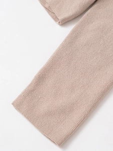 Close-up of oatmeal knitted top showing ribbed cuffs and premium lace stitching detail