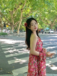 Close-up of a red floral halter dress featuring backless cut and elegant chiffon fabric