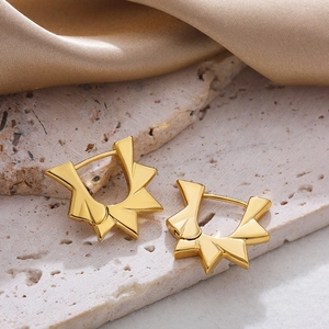 Elegant 18K gold plated stainless steel sunburst earrings on luxury silk background