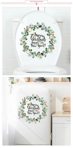 Detail of Christmas wreath stickers with pine leaves and snowman on window and fridge surfaces