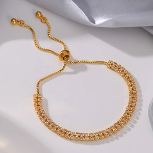 Close-up of adjustable gold tassel bracelet with double-row sparkling cubic zirconia