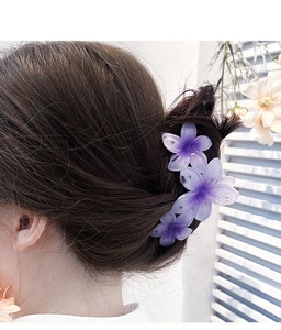 Detail of purple gradient flower hair claw clip on model for styling large hair accessory