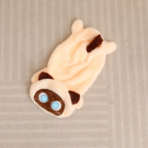 Flat lay of a plush apricot cat toy shell with blue embroidered eyes and brown ears