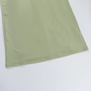Detailed close-up of the double-needle hem on a light green slim-fit lace dress
