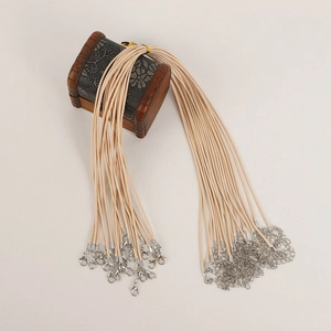 Detail of beige waxed necklace cords with silver lobster clasps and extension chains