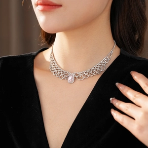 Detail of water-drop pink crystal necklace with rhinestone lace on a model