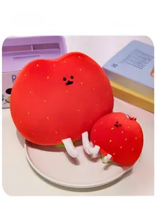 Detail of plush strawberry hash brown dolls in large and small sizes with cute embroidery