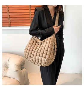 Detailed side view of khaki quilted cloud shoulder bag featuring soft puffer texture