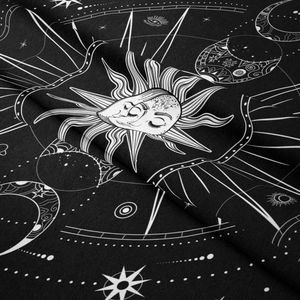 Detailed close-up of Bohemian sun and moon mandala tapestry with soft fabric texture
