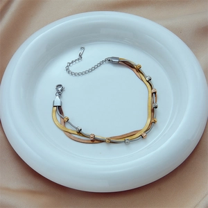 Three-layer titanium steel bracelet with gold, silver, and rose gold snake chain design