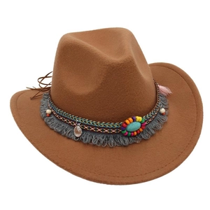 Detail of brown fedora hat featuring bohemian tassel band and turquoise stone accent