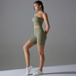 Detail view of olive green yoga set with ruched bandeau top and high waist cycling shorts