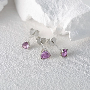 Detail shot of S925 sterling silver studs set with purple heart and round cubic zirconia