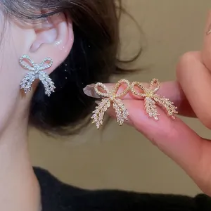 Elegant bow zircon earrings with tassel pendants in gold and silver finish