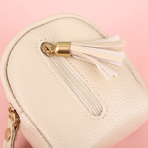 Mini PU leather backpack coin purse in beige with tassel zipper and lychee texture