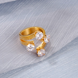 Macro view of adjustable 18K gold plated stainless steel ring with four clear crystals