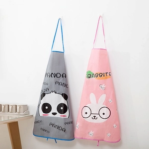 Close-up of waterproof aprons with cute panda and rabbit cartoon prints hanging on a wall
