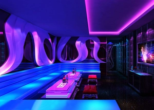 Vibrant bar interior with purple and blue LED strip lights creating a dynamic atmosphere