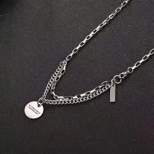 Double layered silver titanium steel necklace with engraved coin and bar pendants