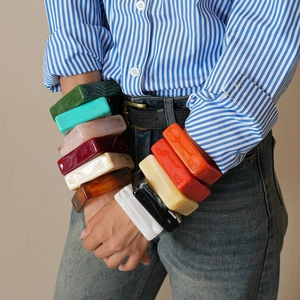 Stacked colorful chunky acrylic bangles showcasing marbled geometric square designs