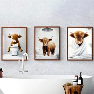 Three framed canvas prints of Highland cows in bathroom scenes over a white bathtub