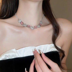 Close-up of elegant pink gemstone flower necklace on model neck with silver base
