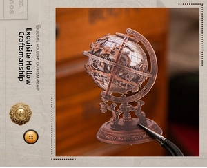 Detailed macro shot of vintage bronze globe sticker with intricate hollow gears for journaling