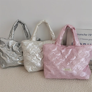 Three quilted bow lunch bags in metallic silver, pearl white, and soft pink colors