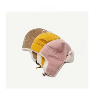 Detail view of winter faux fur trapper hats showing corduroy fabric and warm plush lining