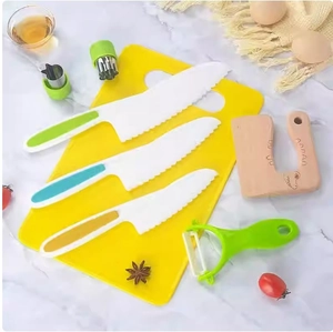 Detailed set of colorful kids plastic knives with wooden cutter and cutting board on marble