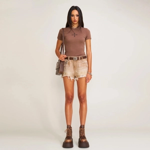 Slim fit brown cross logo T-shirt styled with distressed khaki denim shorts and boots
