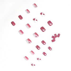 Pink and white gradient press-on nails with heart doodle patterns in short square shape