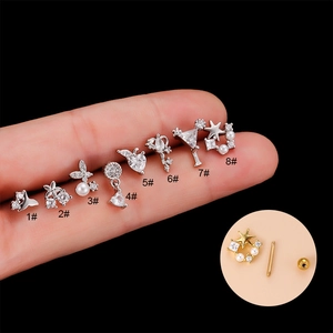 Set of 8 stainless steel screw back earrings with zirconia and pearls on black background