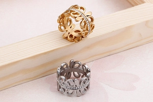 Detailed close-up of hollowed-out rings with single row zircon stones in gold and silver