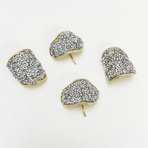 Detailed view of fan-shaped alloy hair clips with gold edges and silver crystals